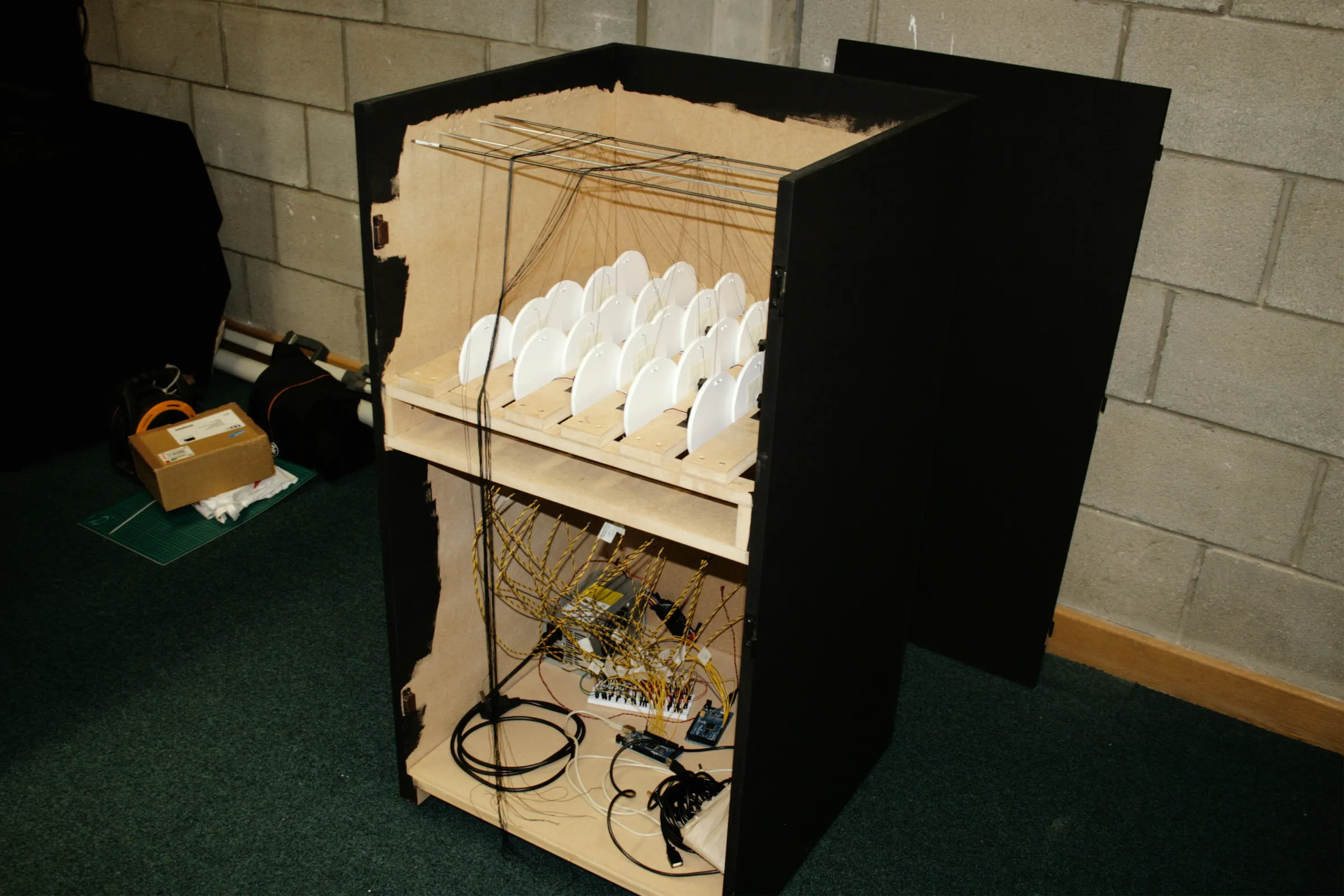 The cabinet opened up, with the disc shelf at the top and the Arduino and wiring on the floor below