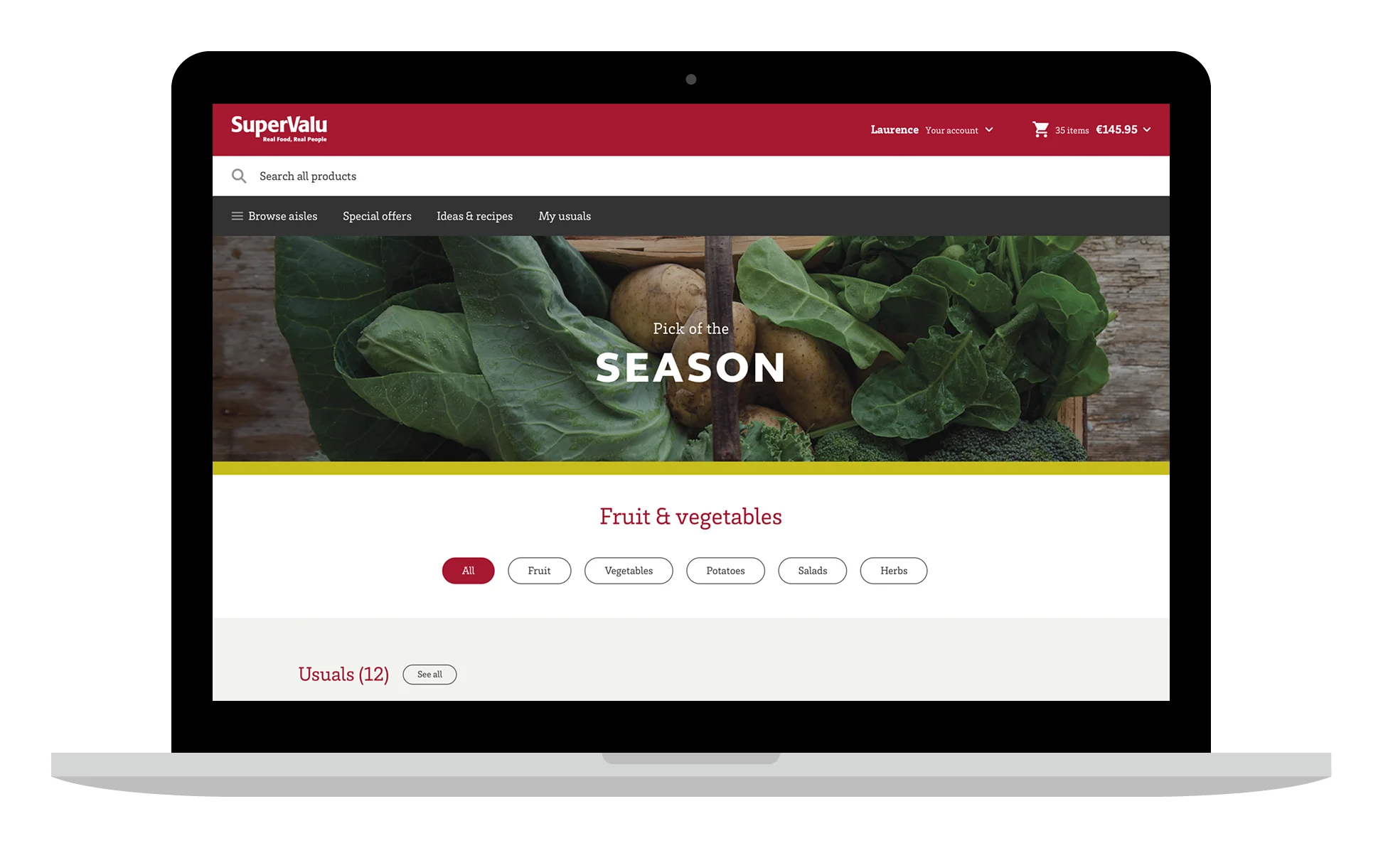 Laptop showing a Fruit & vegetables page with a Pick of the Season banner and filter buttons