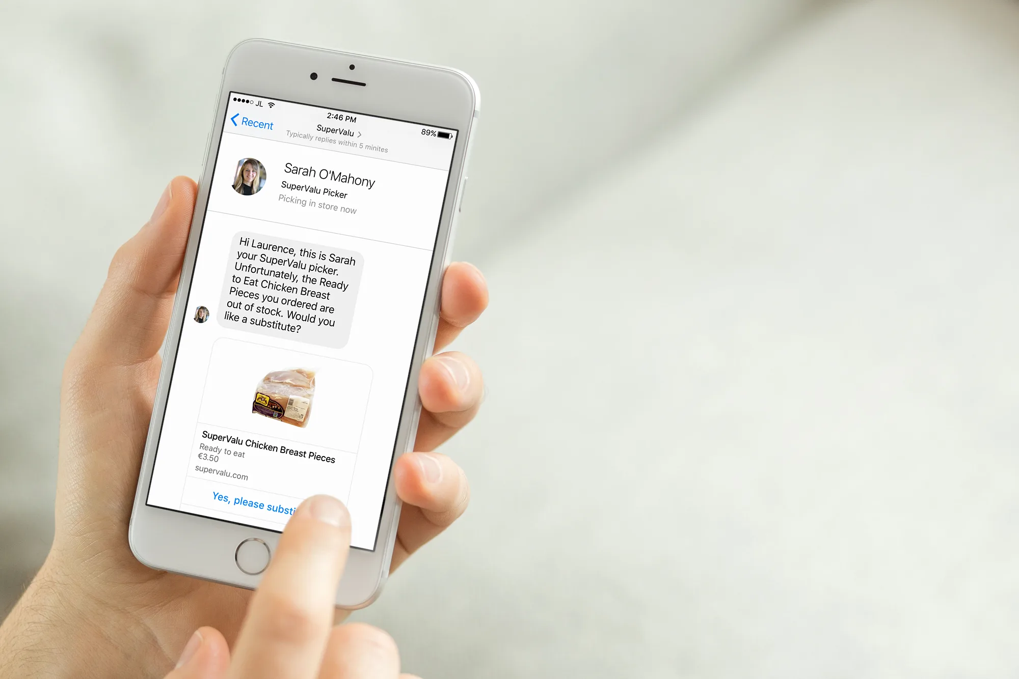 A hand holding a phone showing a message from a SuperValu picker offering a substitute product